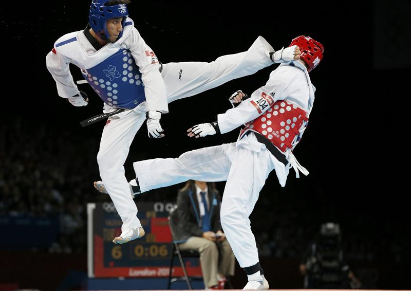 Turkey's Servet Tazegul kicks Britain's Martin Stamper during their men's -68kg semifinal taekwondo match at the London Olympic Games