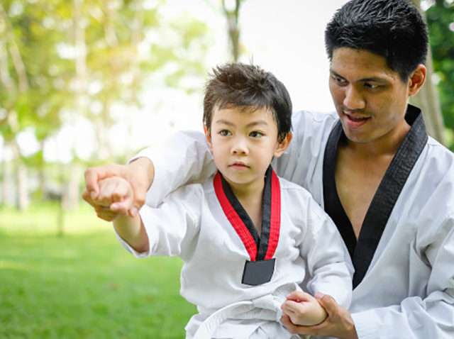 father-is-teacher-teaching-taekwondo-kids-children-boy-are-learning-nature_33855-172