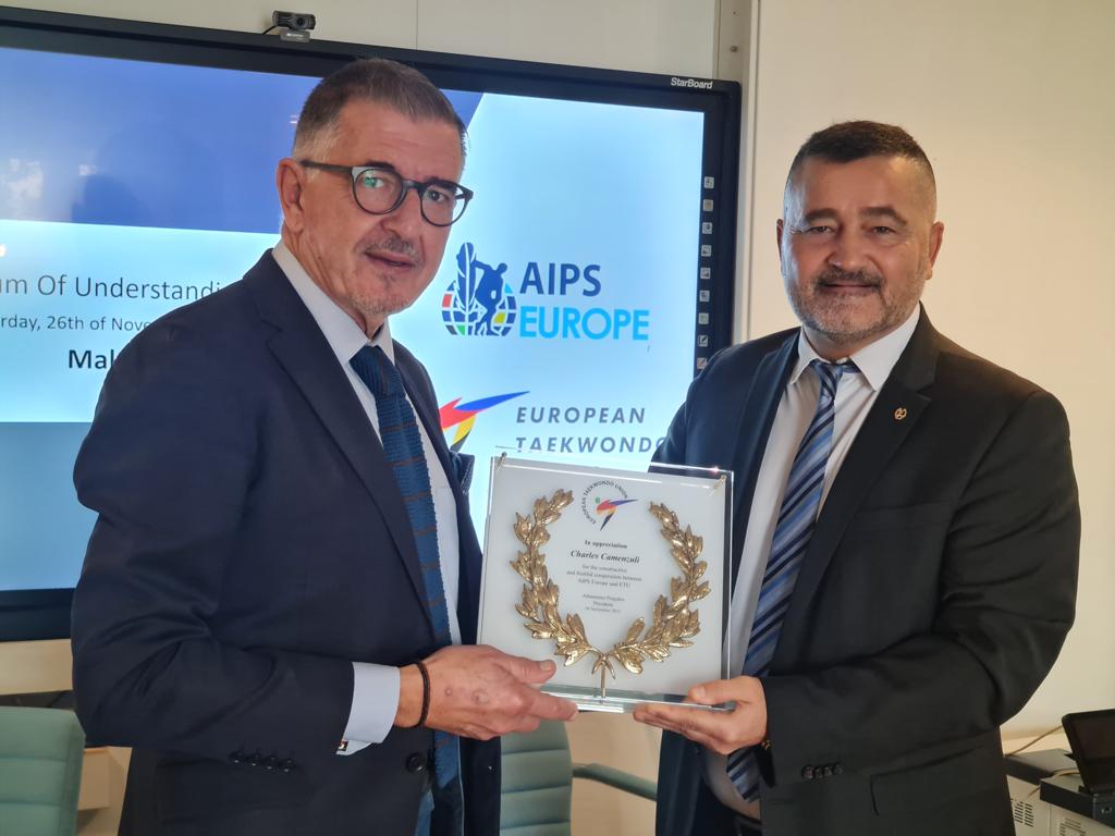 The ETU Secretary General, Mr. Antonio Barbarino gives to the AIPS Europe President, Mr. Charles Camenzuli, a plaque for his contribution to taekwondo sport.